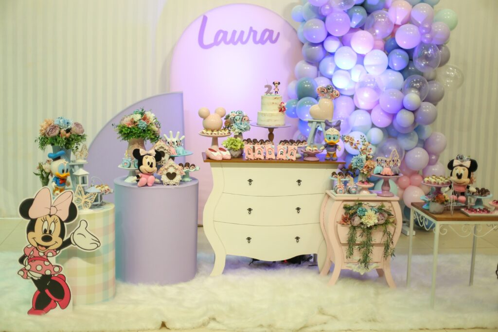 A vibrant Minnie Mouse themed birthday setup with balloons and decor.