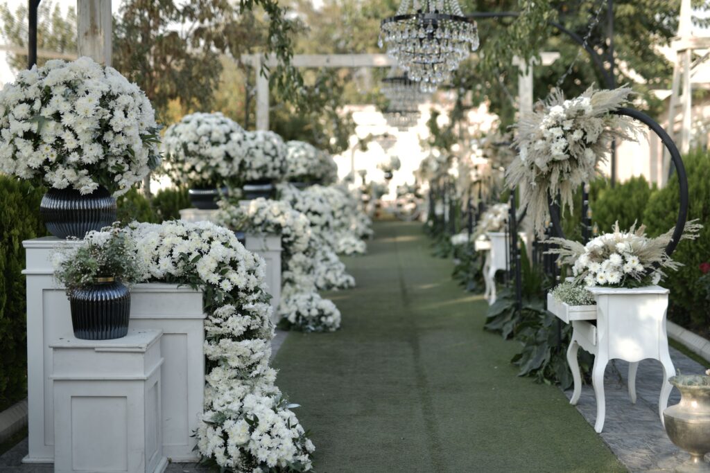 Beautiful outdoor garden scene with elegant white flower arrangements, ideal for weddings.
