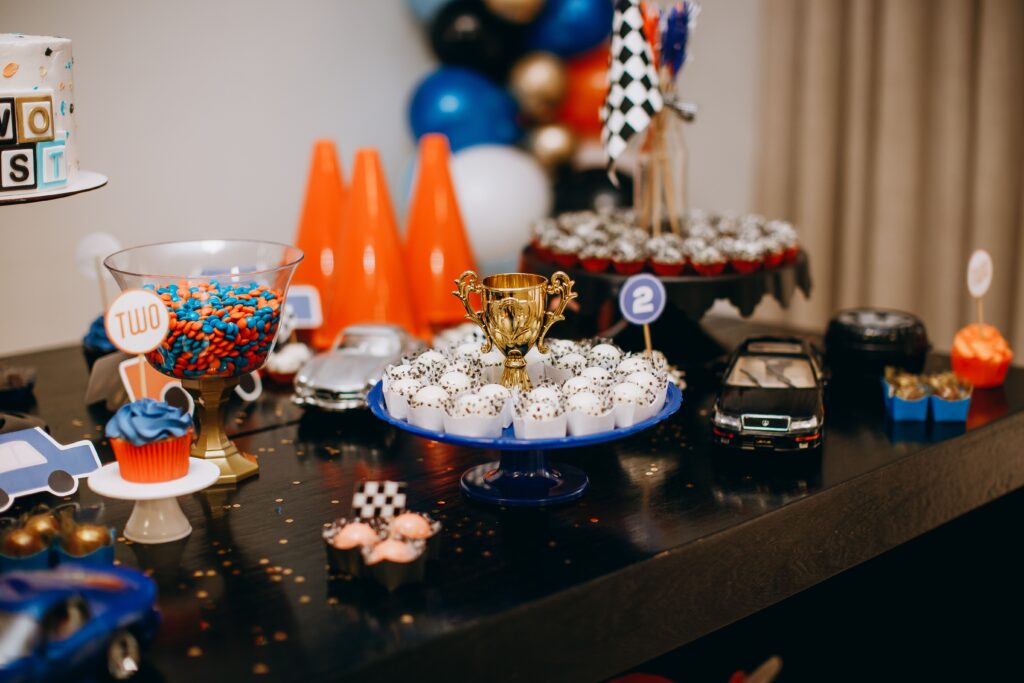 Vivid kids birthday table setup with cakes, candies, and decorations, perfect for a celebrations theme.
