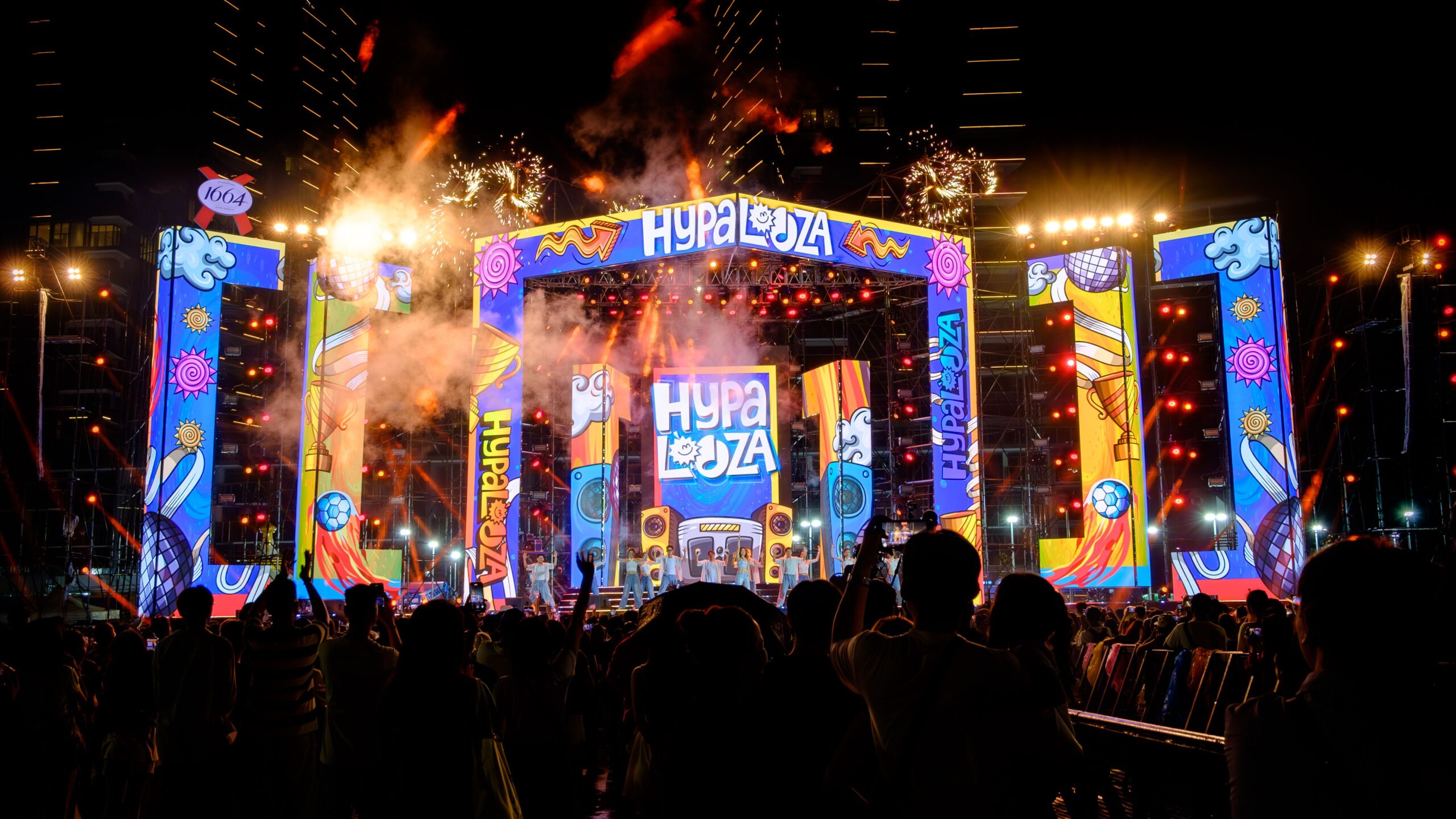 Bright and lively festival night with fireworks and neon lights in Ho Chi Minh City, Vietnam.