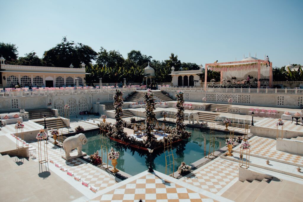 Beautifully decorated outdoor wedding venue with floral arrangements and poolside setup.