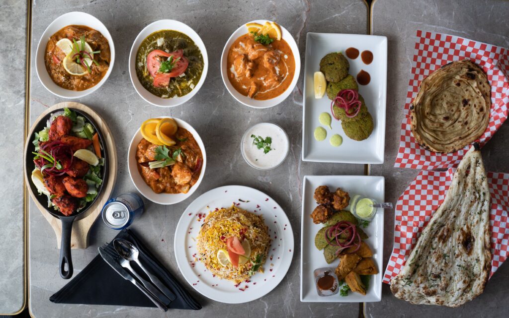 A diverse selection of Indian dishes beautifully arranged in an overhead view.
